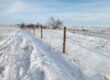 Farm fence in the winter in Alberta
