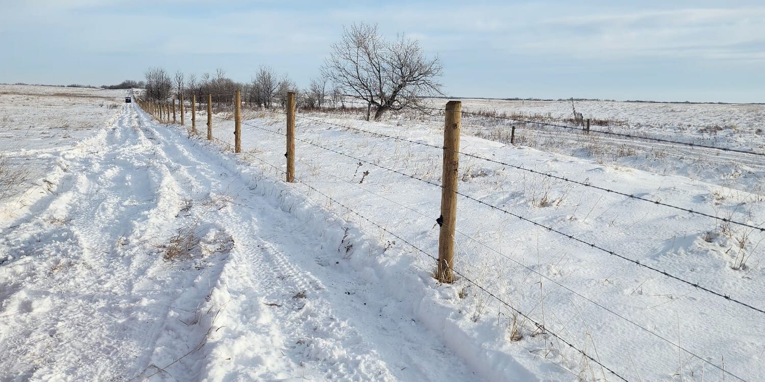 Farm fence in the winter in Alberta